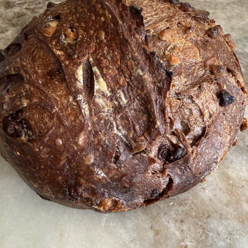 A dark chocolate sourdough loaf on parchment