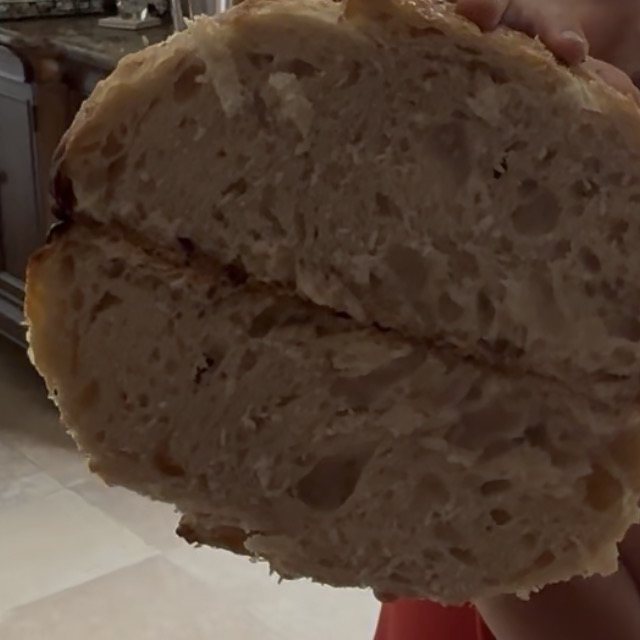 The open, airy crumb of a cut sourdough loaf
